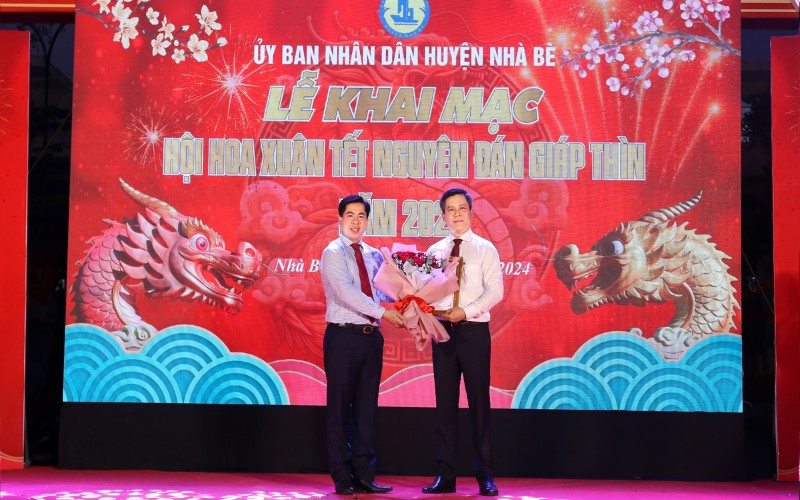 Ông Triệu Đỗ Hồng Phước - Phó Bí thư Huyện ủy, Chủ tịch UBND Huyện Nhà Bè (Trái) trao tặng thư cảm ơn choông Huỳnh Bảo Đức - Tổng Giám đốc HIPC